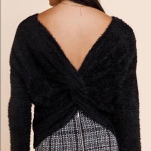 Black XS Francesca’s sweater twisted back.
